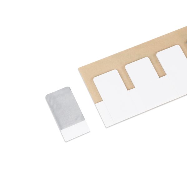 Close-up reveals PET, aluminum foil, and foam construction of the UHF On Metal Label embedded with NXP UCODE 8 chip.