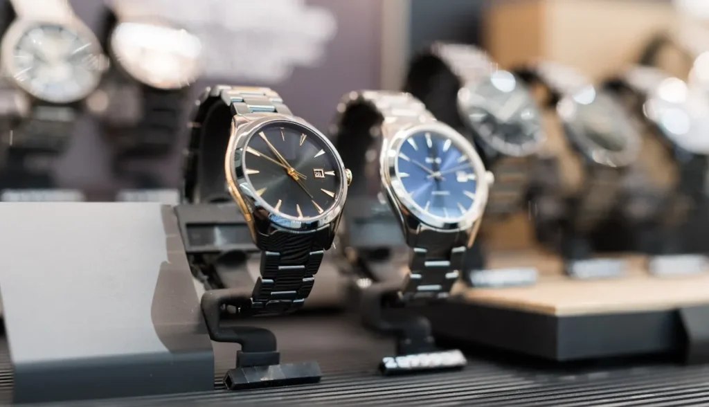 Luxury watches displayed in a retail case, representing high-value goods vulnerable to counterfeiting.
