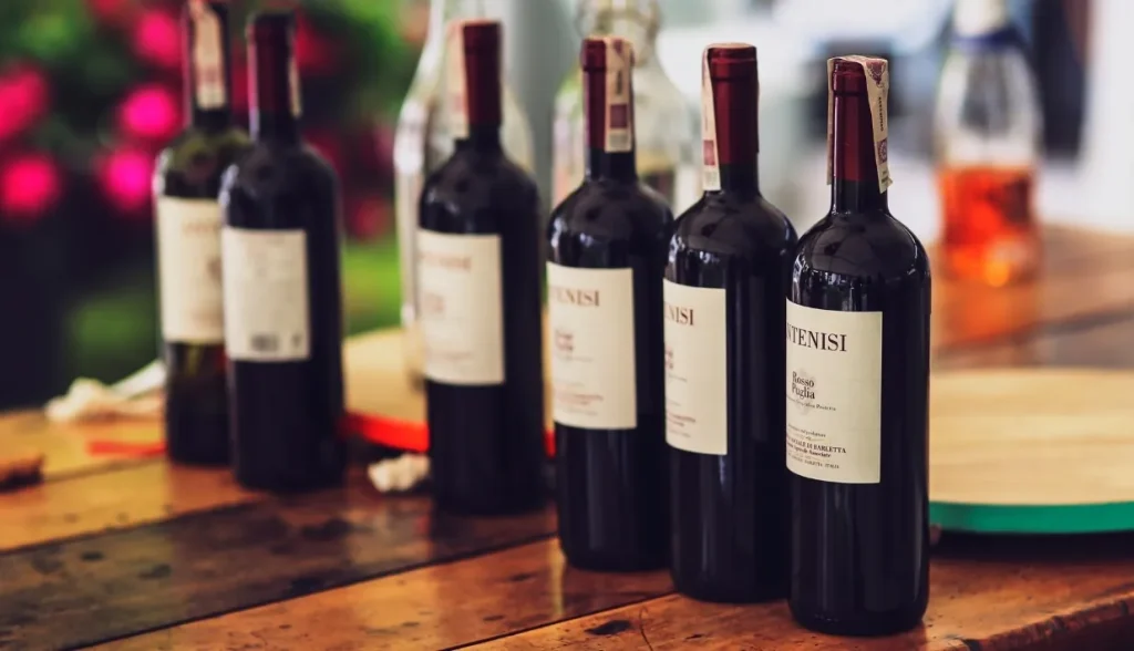 Bottles of premium wine lined up, showcasing the high-value beverage industry’s counterfeiting risks.