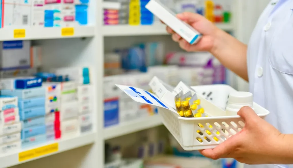 Pharmacist sorting prescription medications on pharmacy shelves, demonstrating RFID inventory management for medical supplies.